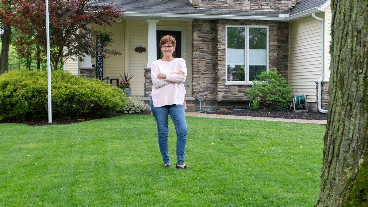 customer standing in front lawn green lush