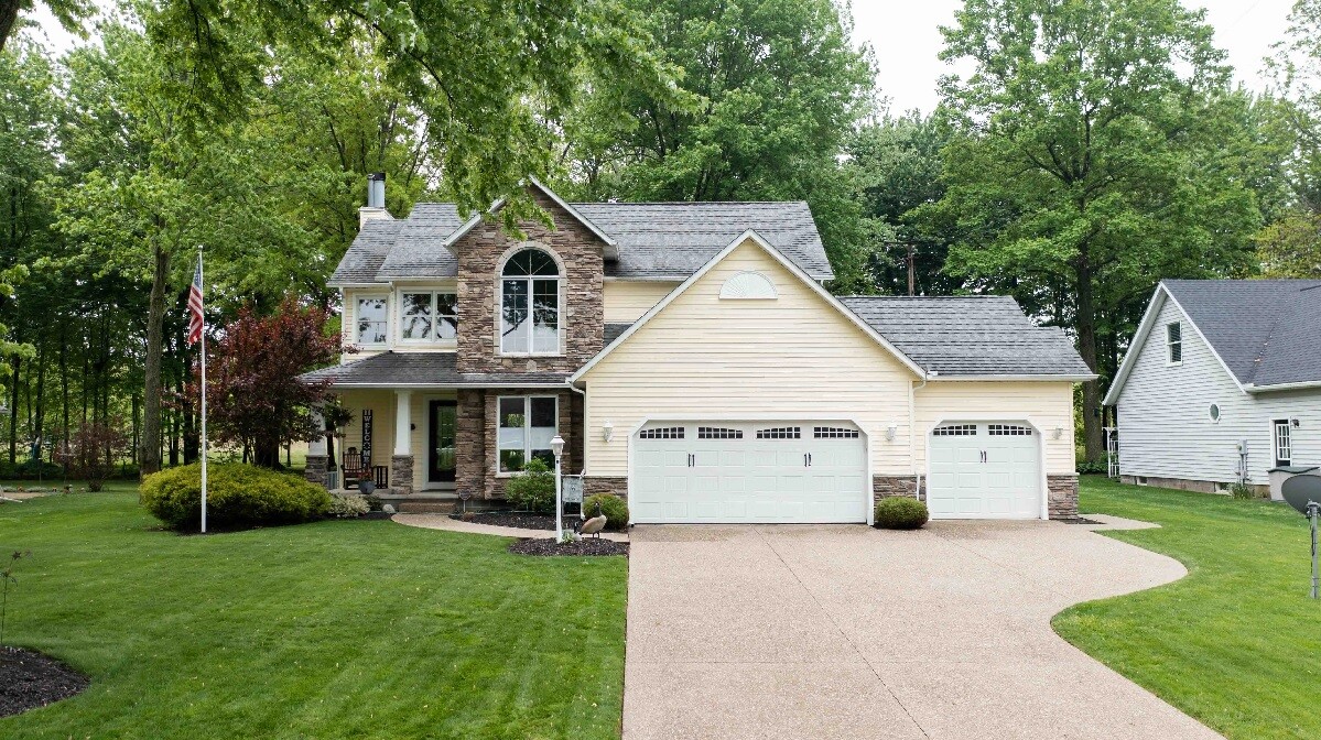 front of house large trees and green lawn