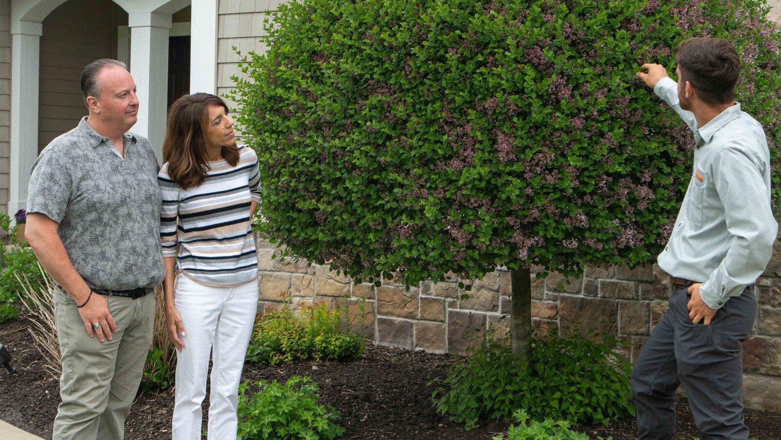 looking at how trees and shrubs are trimmed with clients 