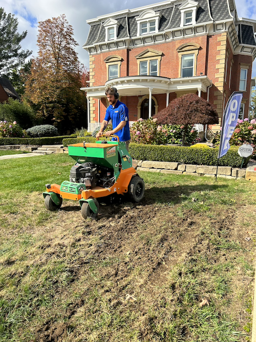 crew on machine aerating and overseeding lawn 1