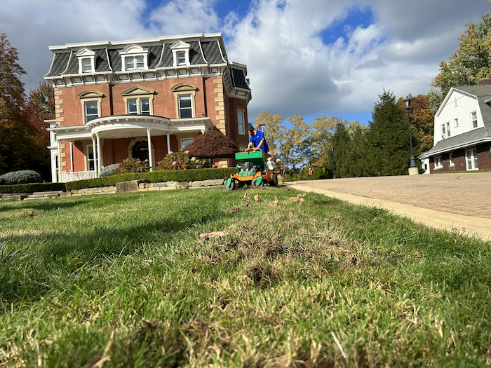 crew on machine aerating and overseeding lawn 10