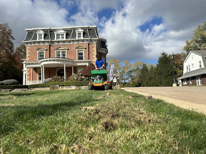 crew on machine aerating and overseeding lawn 7