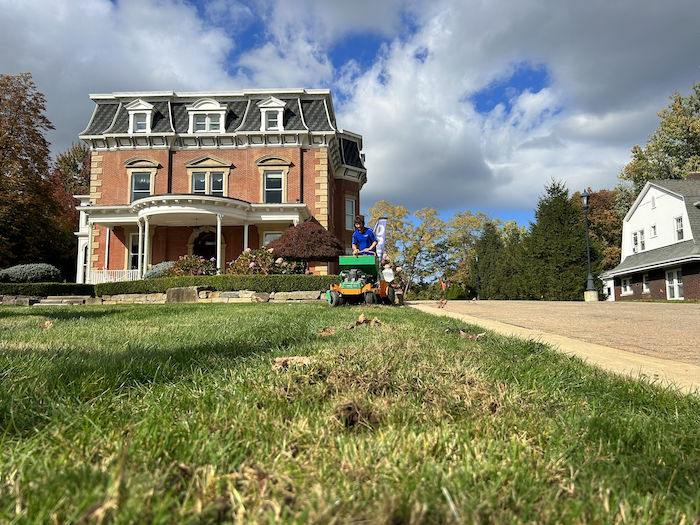 crew on machine aerating and overseeding lawn 9