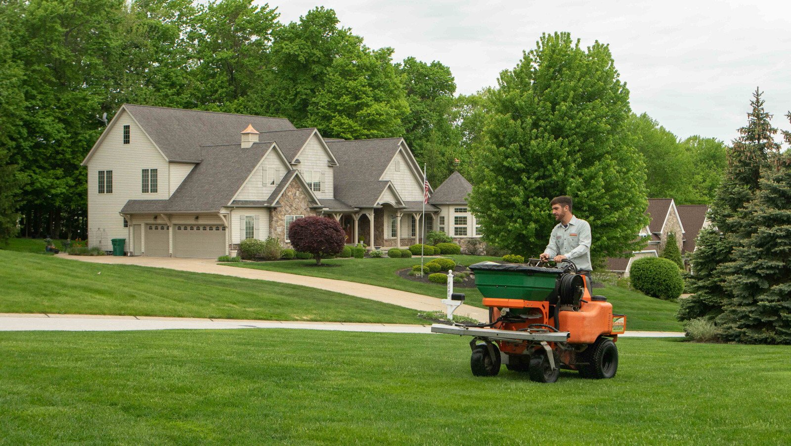 Lawn technician fertilizing lawn