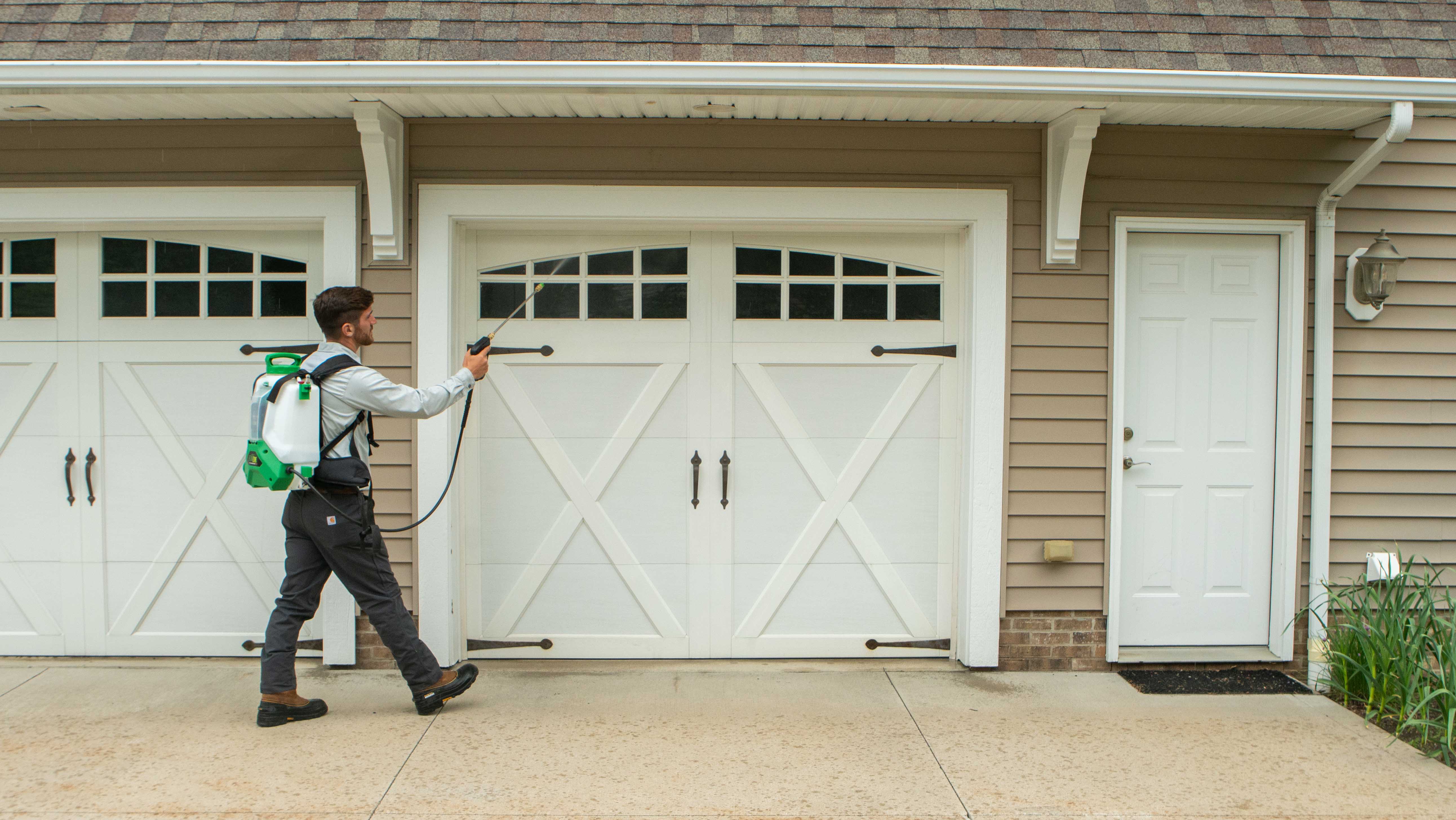 technician spraying perimeter pest control