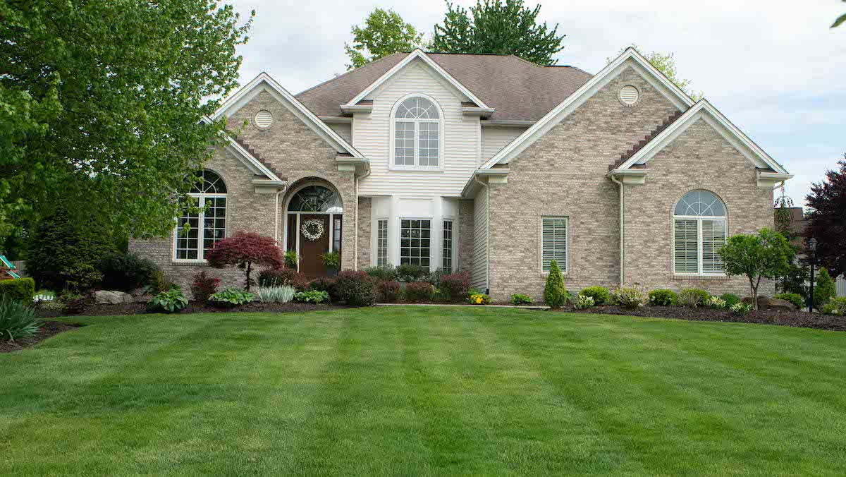 lush green lawn with house and landscaping