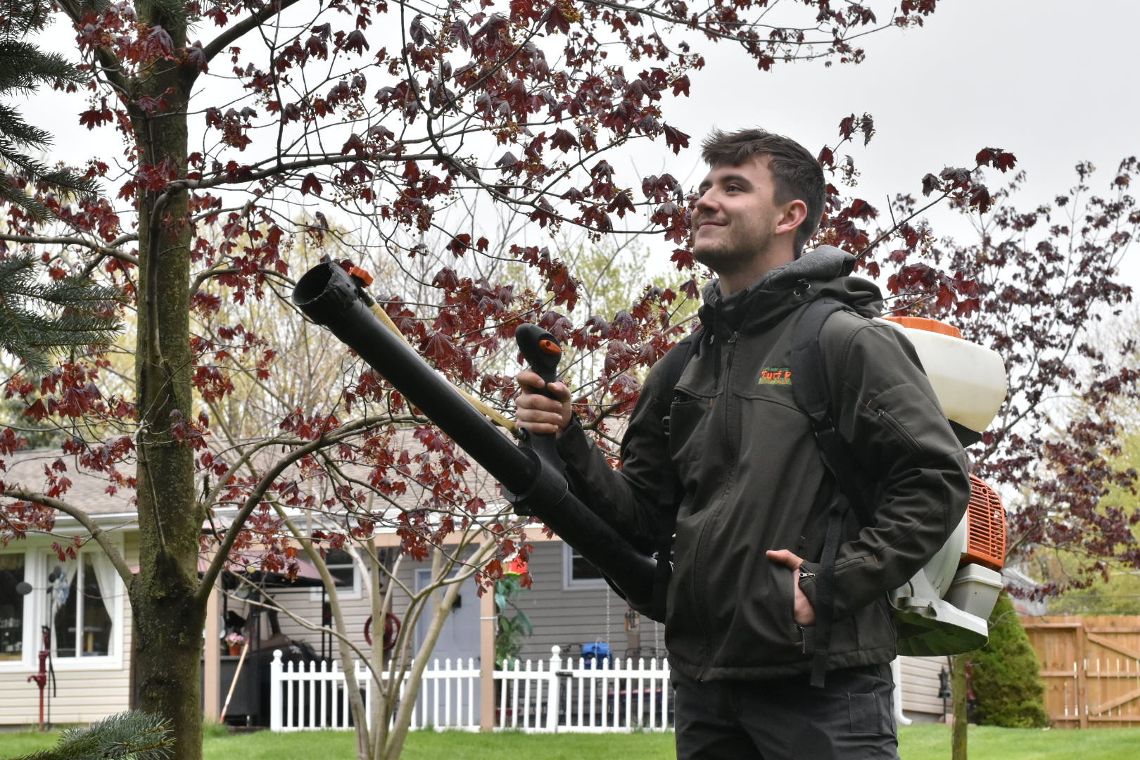 crew member treating yard for mosquitoes 